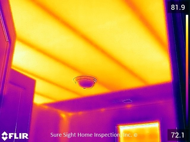 Thermal image showing heat escaping through poorly insulated attic